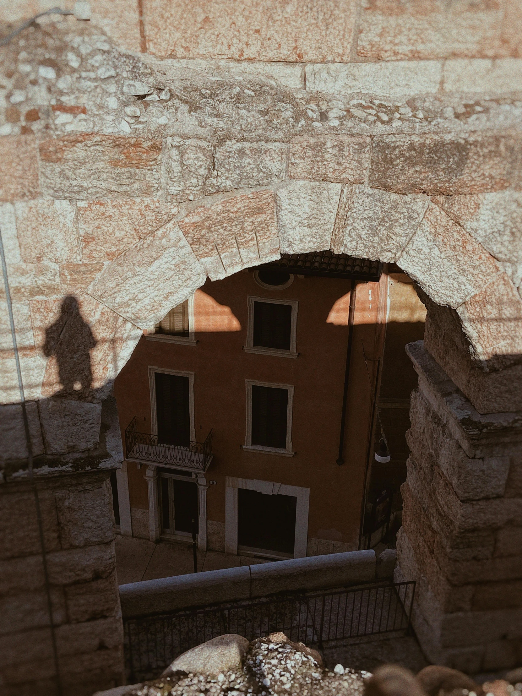 an ancient arch made of bricks and concrete with windows between it