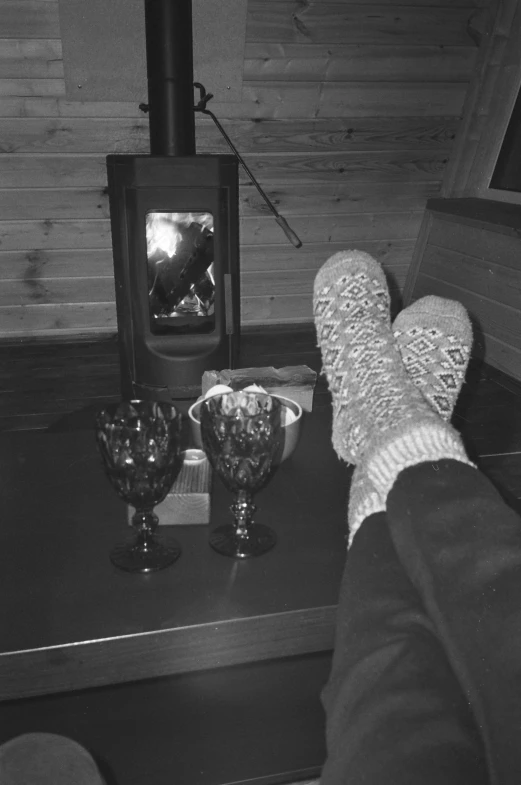 a person wearing socks sitting on a table near an object