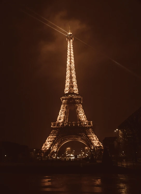 a night view of the eiffel tower with boats