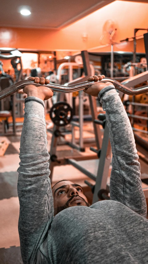 a man using the barbells in a gym