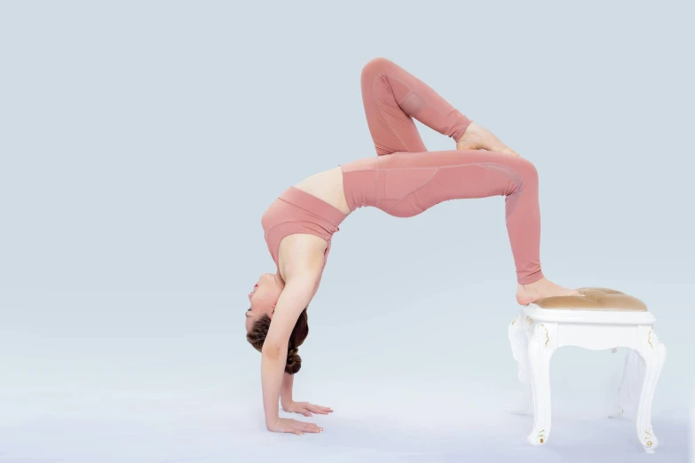 a woman doing a hand stand with her legs in the air