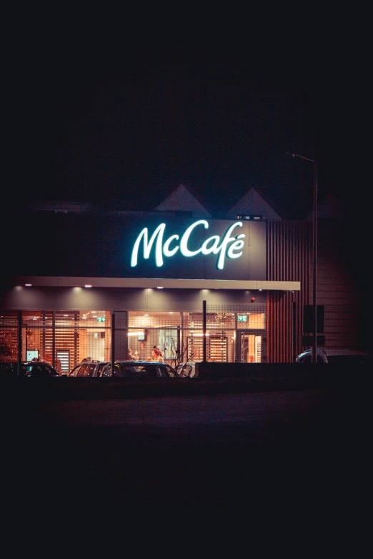 a mcdonald's in a dark building with it's lit sign at night