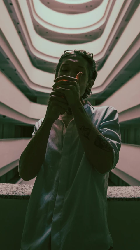 a man taking a picture in front of the ceiling with a cell phone