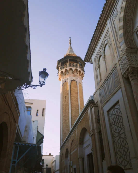 a large clock tower next to tall buildings