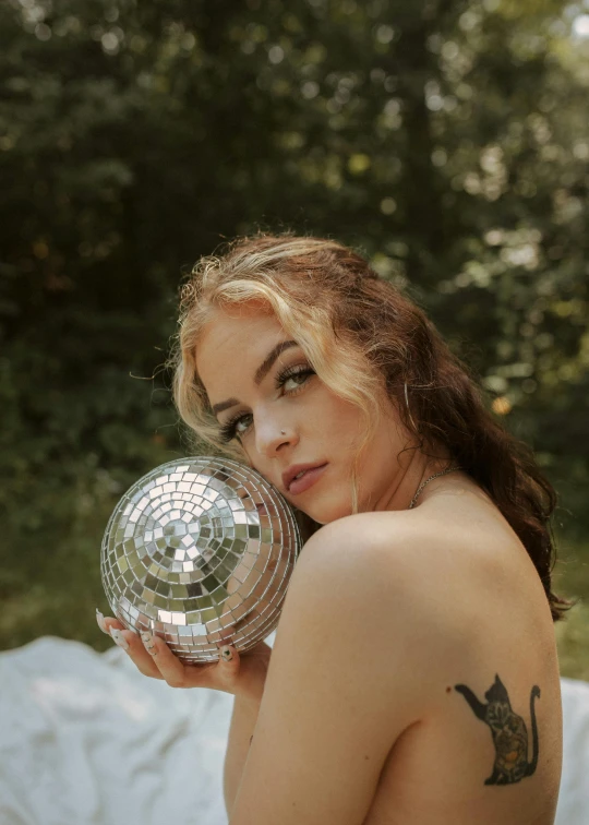 the woman is posing for a po with a disco ball