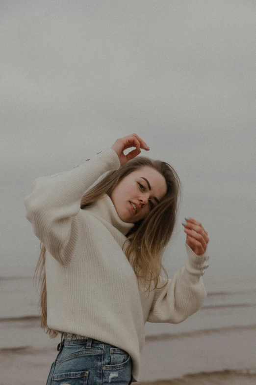 a young woman wearing blue jeans and sweater