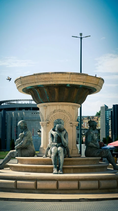 two statues of elephants are sitting on the edge of a fountain