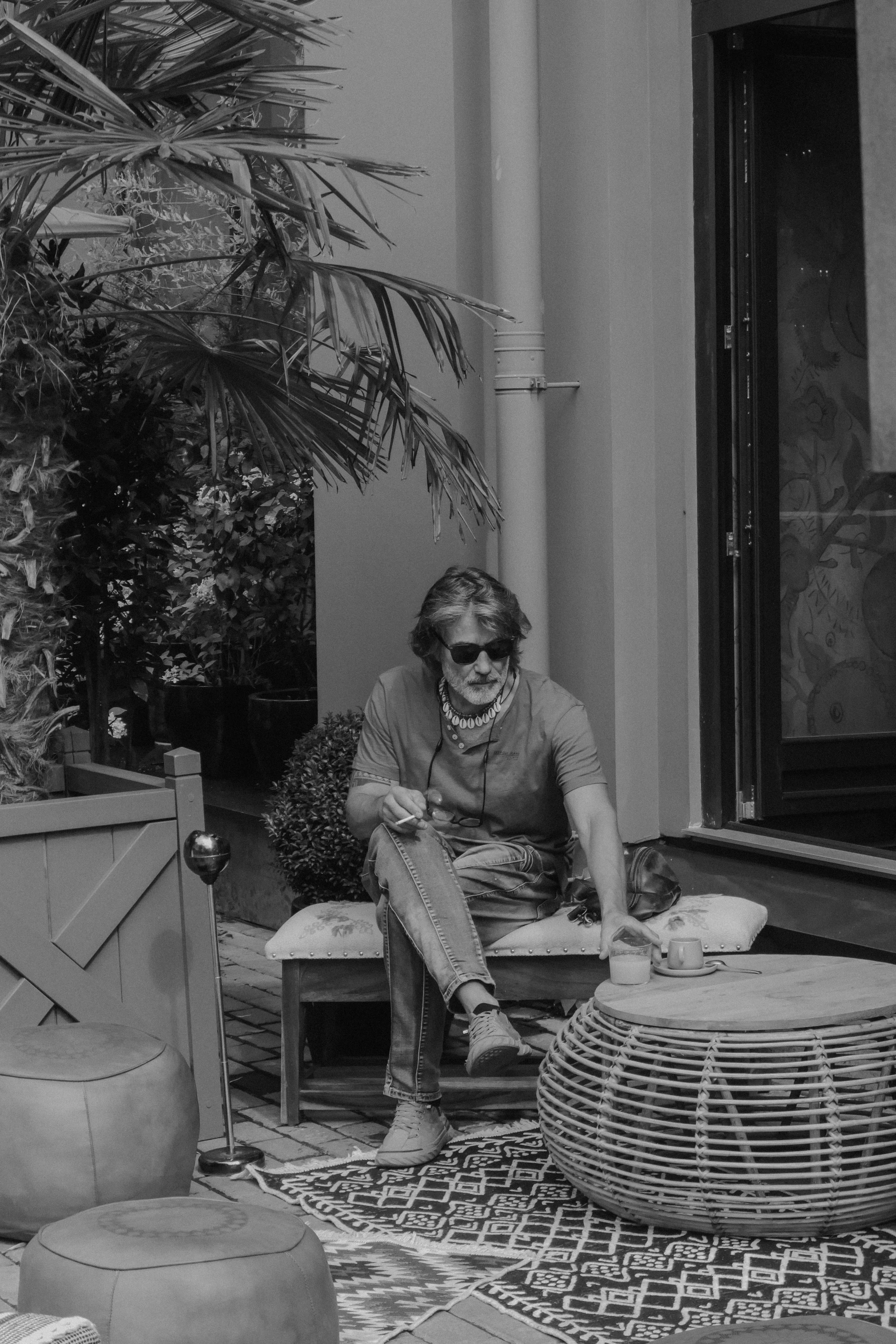 a man sitting in a chair in front of a building