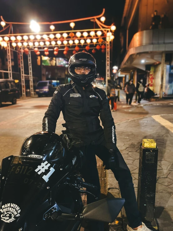 the man is sitting on the motorcycle posing for the po