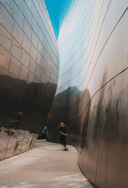 a boy stands in front of a wall next to the building