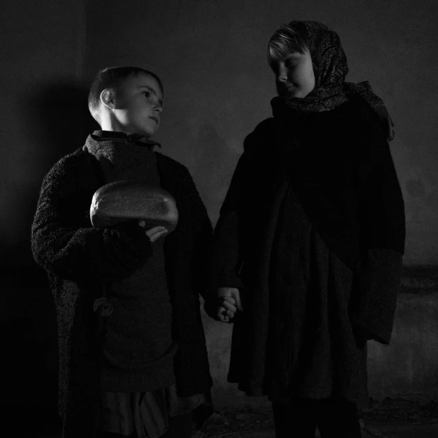 two people holding hands in a dark room