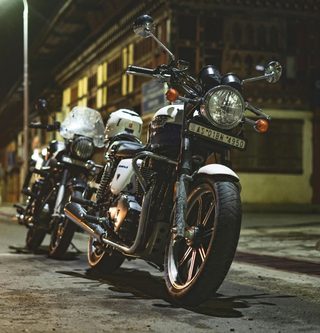 a row of motorcycles parked along the side of a street