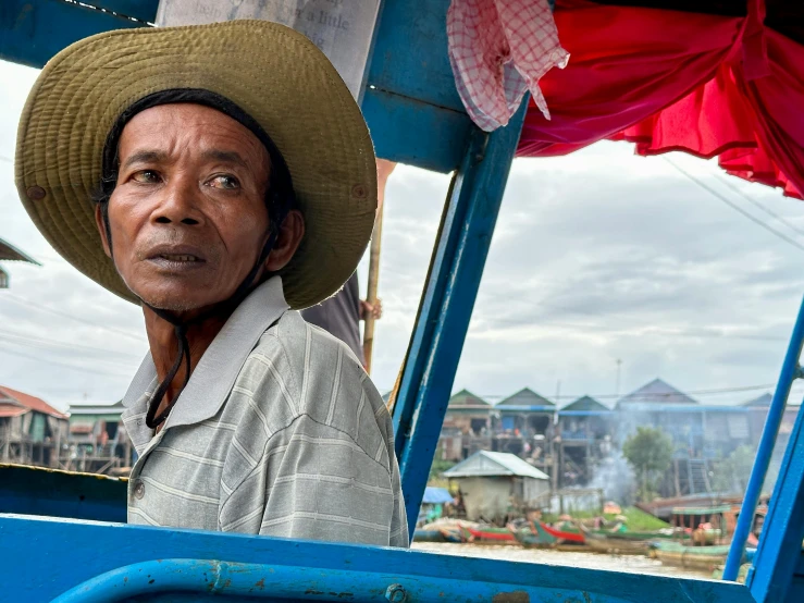 a person with a hat on the back of a boat