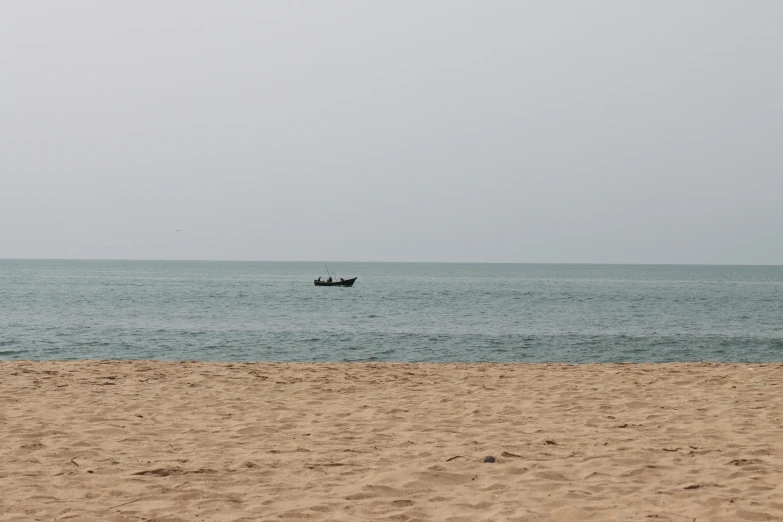 two boats out in the water on a beach