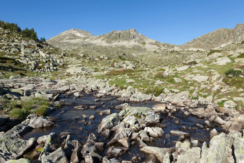 a river flowing down a rocky mountain slope