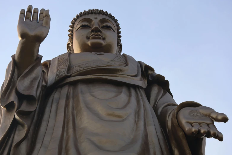 statue of a hand reaching up to the sky