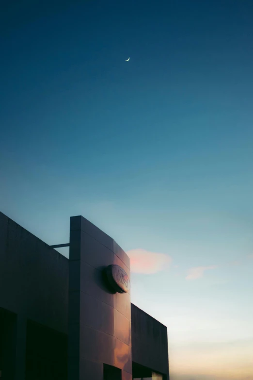 the setting sun reflecting off a building, and an airplane passing by