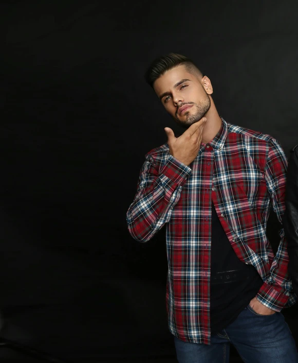 a man poses for a po with a dark background