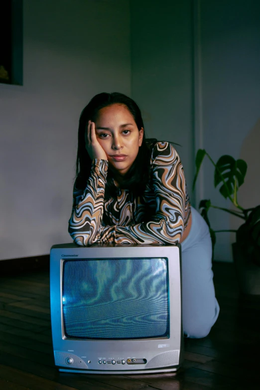 a woman sits in front of a tv