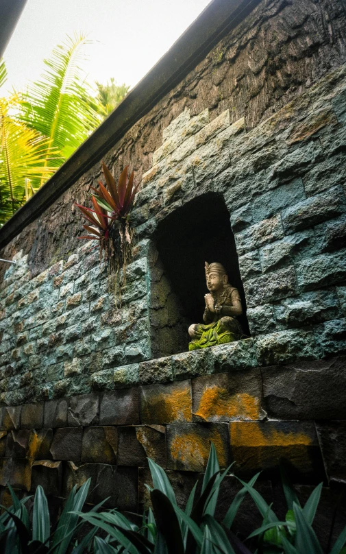 a stone cave entrance with a statue of a monkey