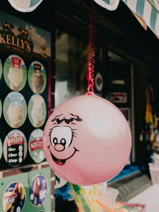 balloon with pink nose hangs from a string