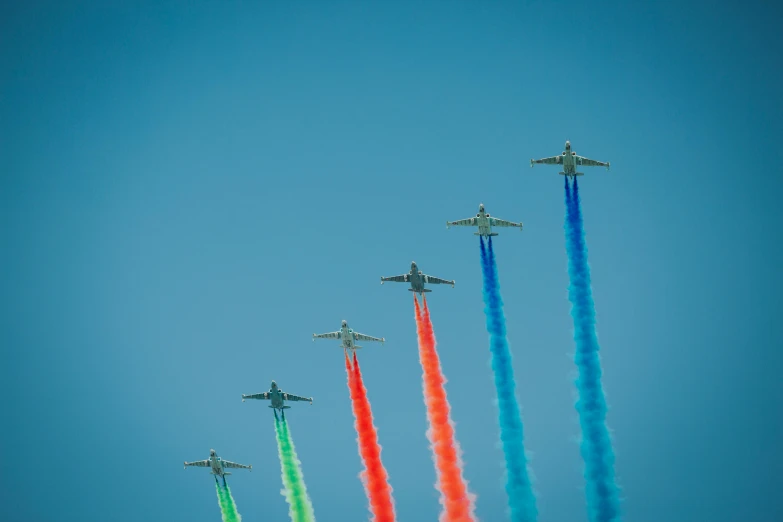 a group of planes in the sky flying through the air