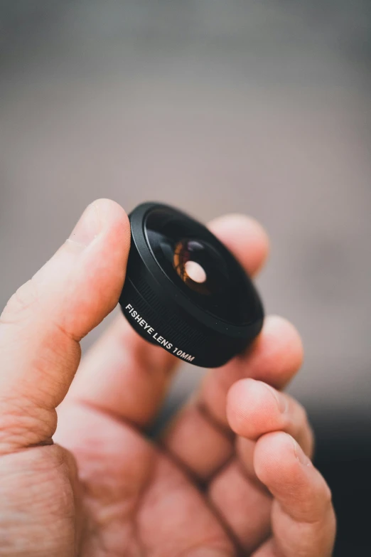 a close up of a person holding an item