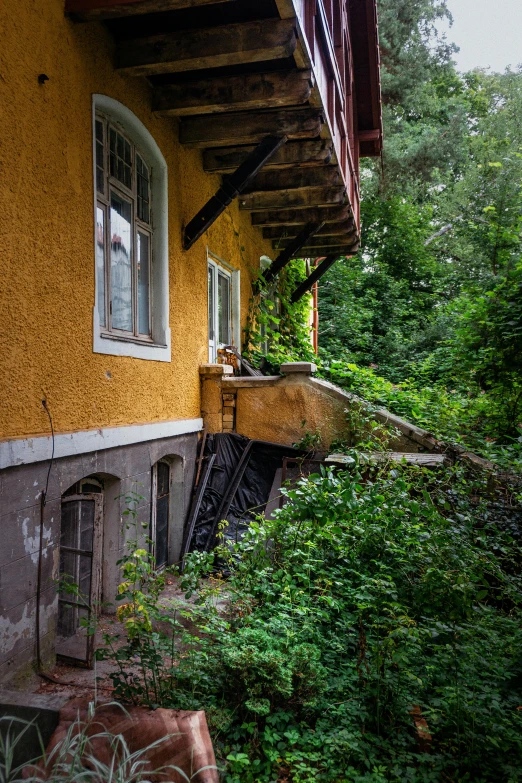 a building with a wooden roof and a covered porch with potted plants