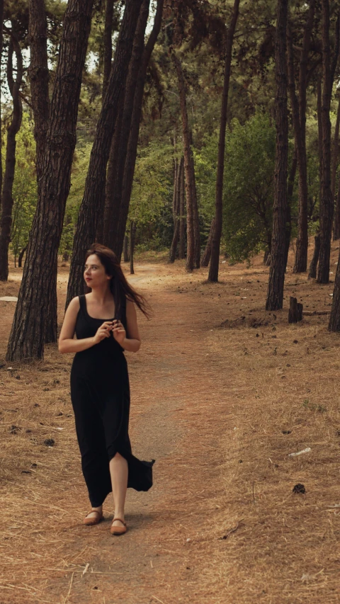 a woman is running through the forest