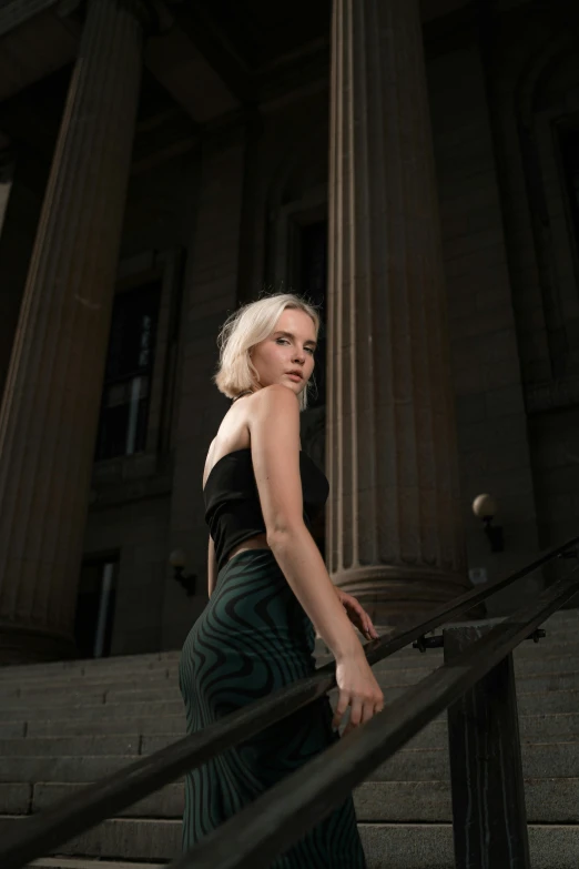 a woman in a dress and heels on steps