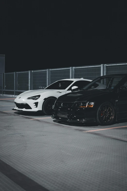 two black and white cars sitting next to each other