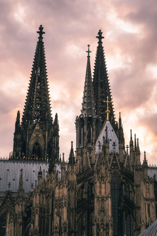 large cathedral against cloudy sky with two spires