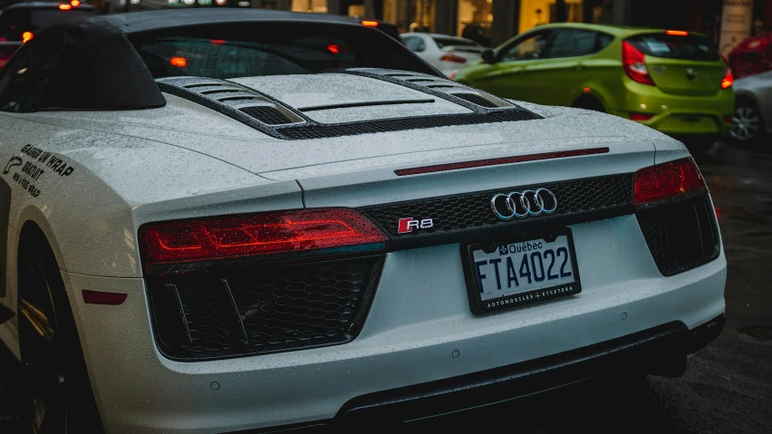 the rear end of a car that is painted white