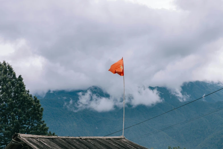 a orange flag on top of a wooden roof