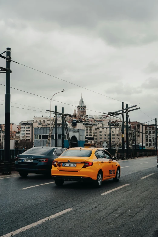 a couple of cars traveling down a street