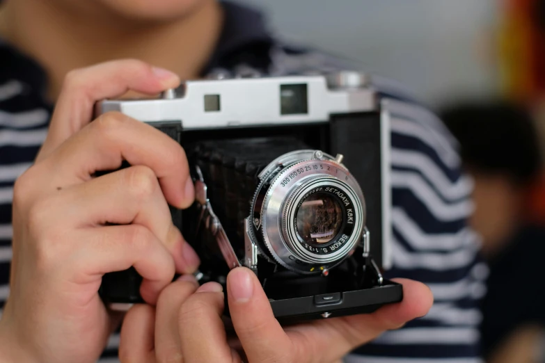 person holding a camera taking pictures with the phone