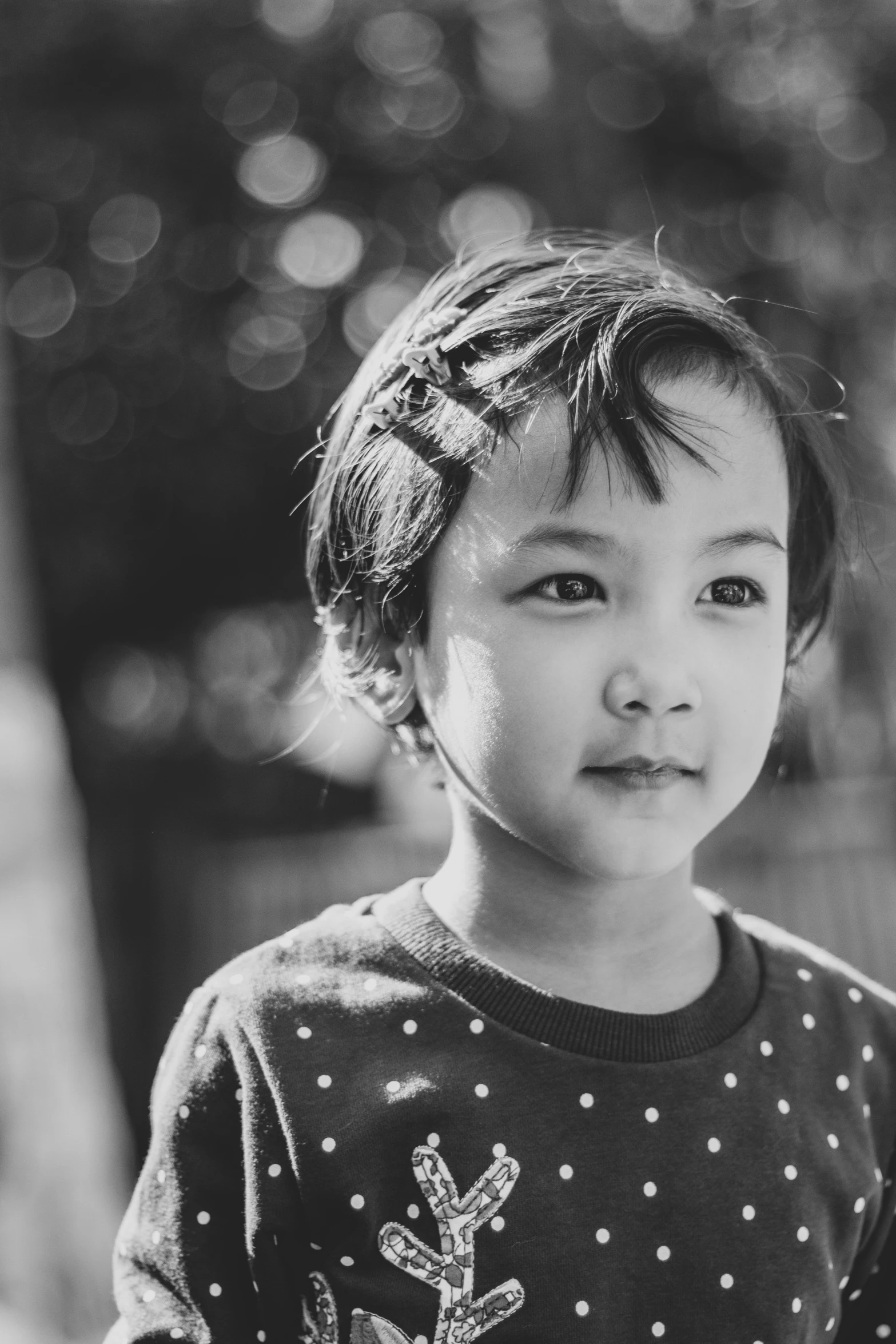 a black and white po of a  wearing a top knot