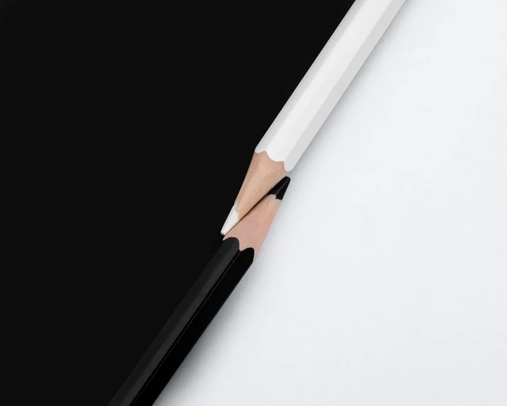 pencil with a wooden end resting on black background