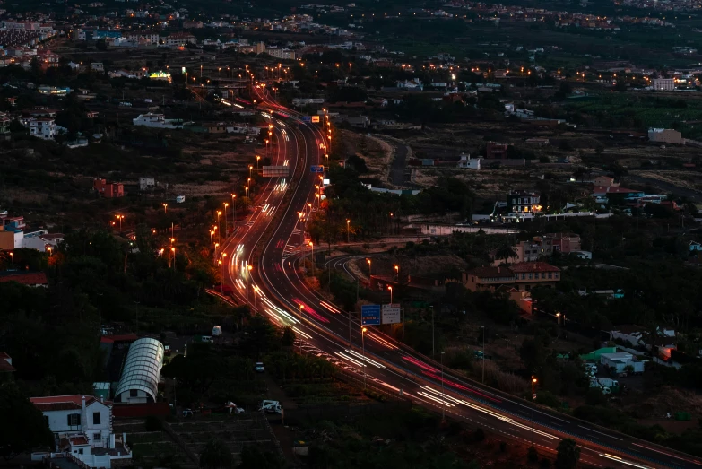 a city skyline with a busy highway, a traffic signal and a mountain in the background