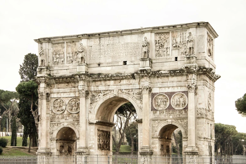 an ancient arch is set against a cloudy sky