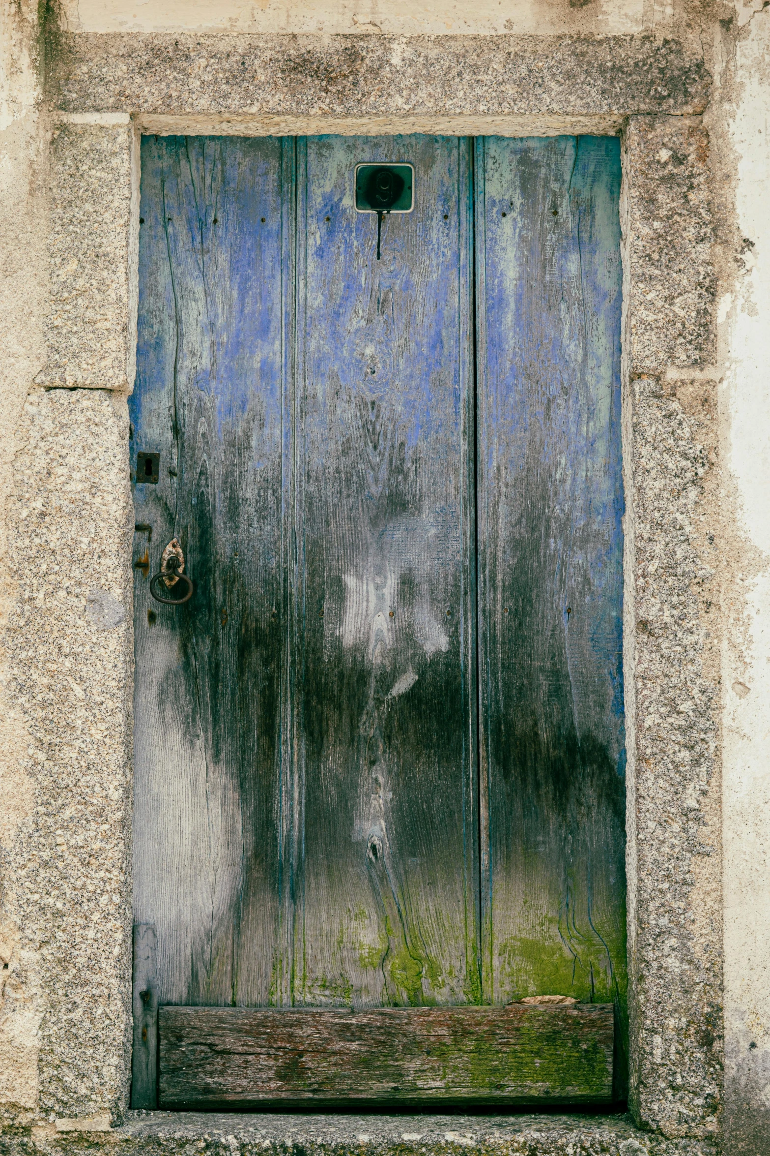 an open wood door with a brick wall