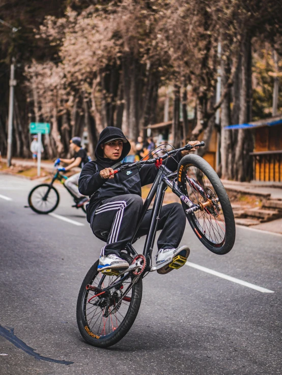 a boy jumping with his bike in the air