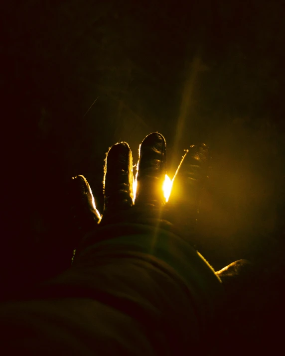 a person holding a flashlight at night time