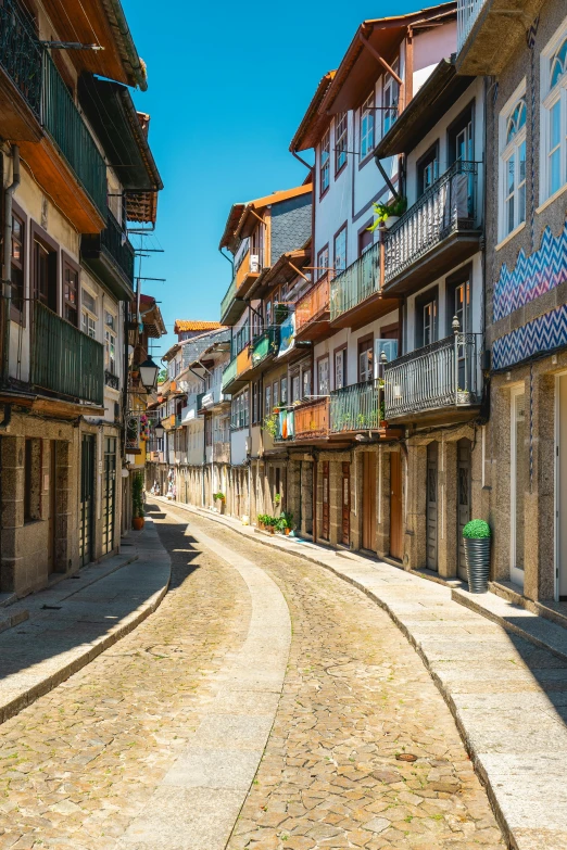 the sun shines on a cobbled street in the old part of town