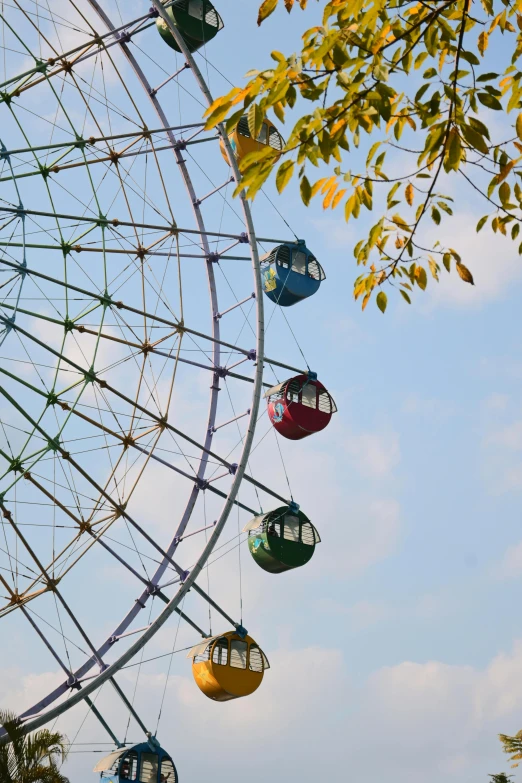 a ferris wheel with many colored seats hanging from it