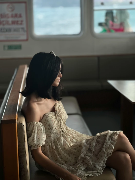 a beautiful young woman sitting in a train station