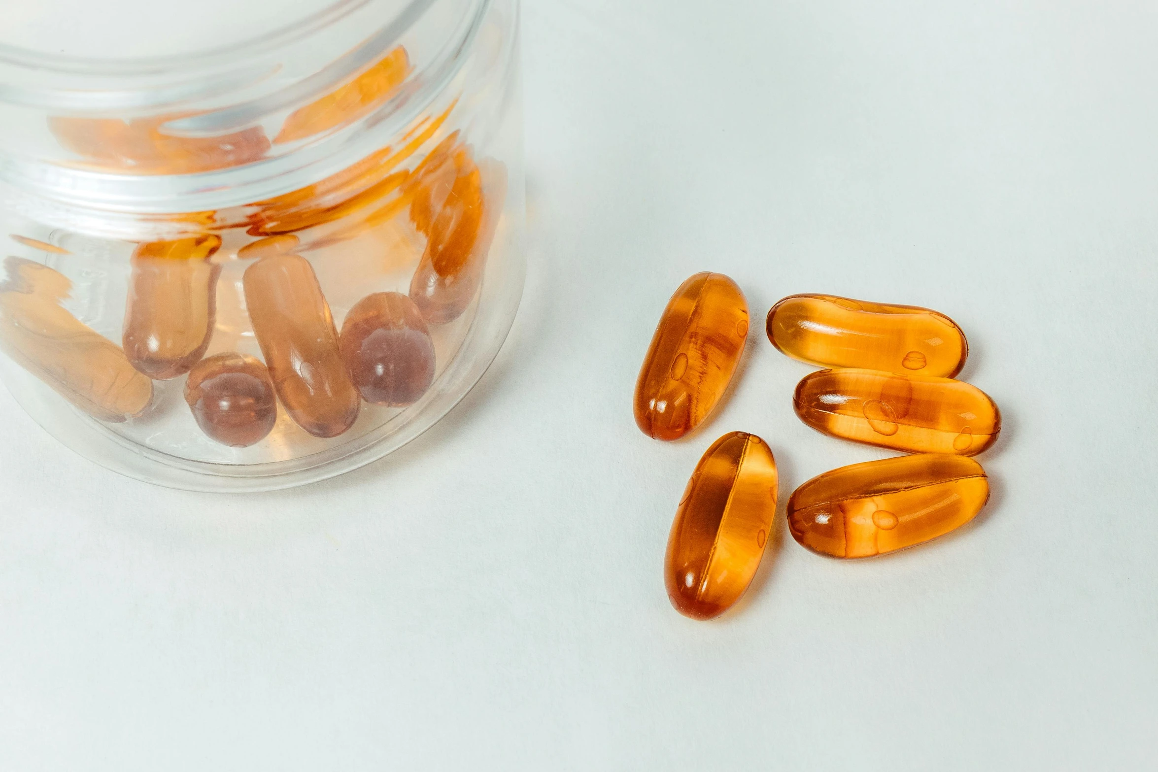 fish oil capsules are shown in a glass container