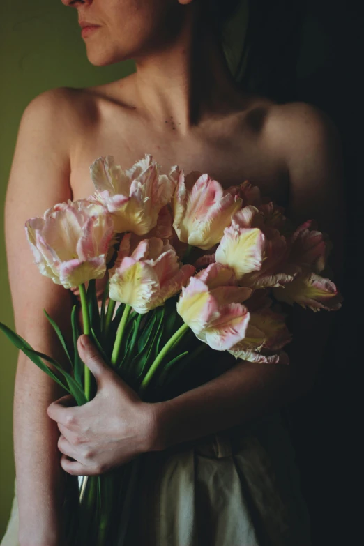 the woman is holding a bunch of flowers by herself