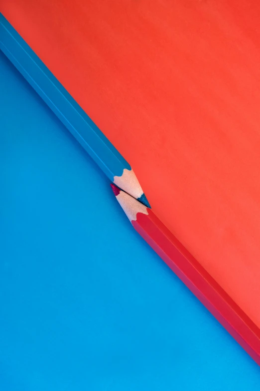 a red pencil sticking out of a blue paper