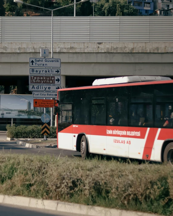 there is an empty public transit bus traveling down the street